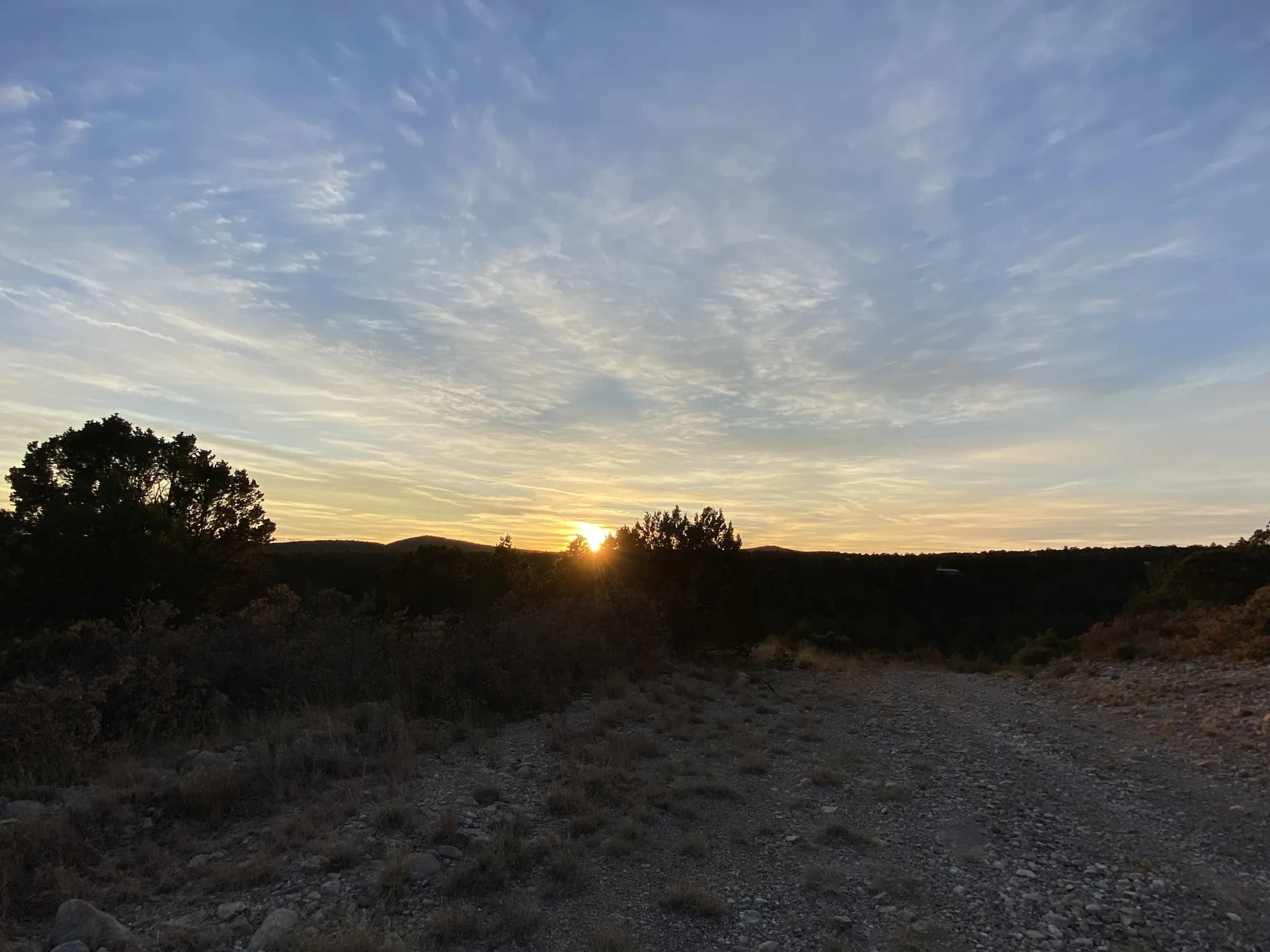 Gravel road along the lots at sunset